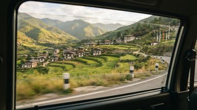 Car passing traditional village Gynekha