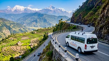 White van driving mountain highway 202607050950