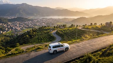 White vehicle driving winding road 202607050955