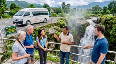 Travelers and guide at waterfall 202607051001